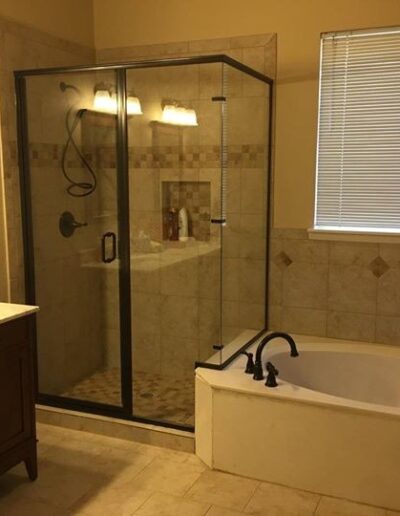 Modern bathroom with a glass shower enclosure and a separate bathtub.