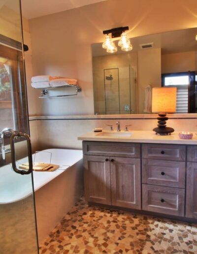 Modern bathroom interior with a freestanding tub, double vanity, and walk-in shower.